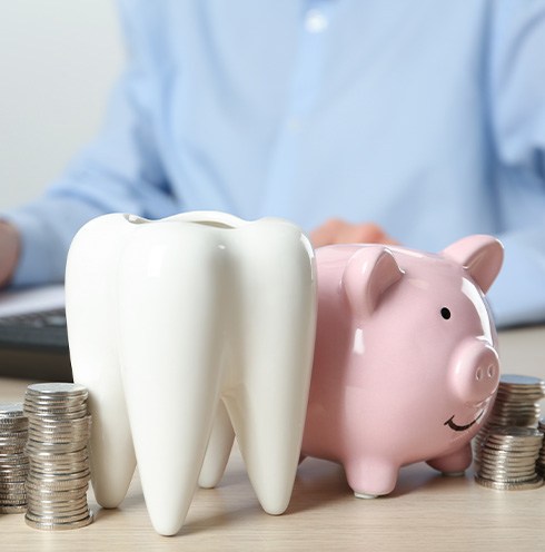 Coins next to a piggy bank