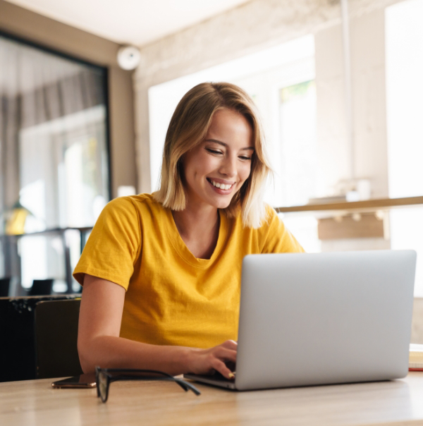 Woman smiling while using laptop