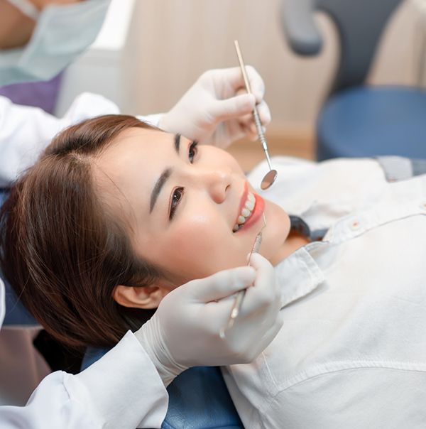 Woman smiling during a dental checkup