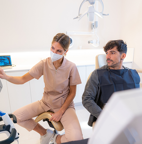 Dentist showing a screen to a patient