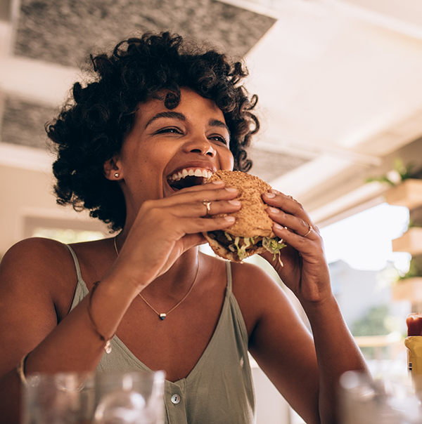 Woman biting into a burger