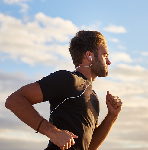 Man jogging while wearing earbuds