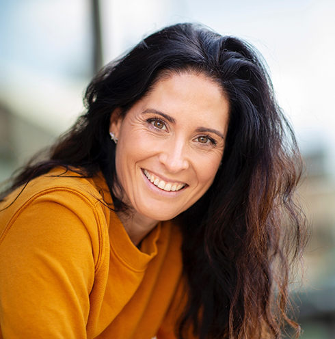 Smiling woman in orange sweater