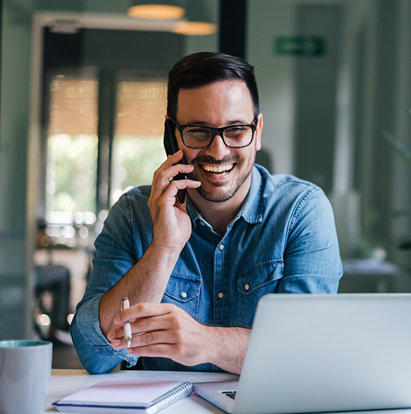 Man smiling while talking on phone