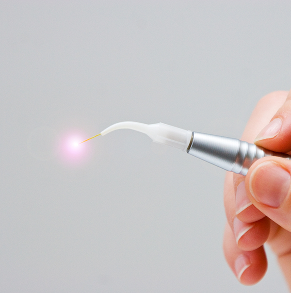 Hand holding a pen like dental laser device