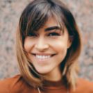 Smiling woman in burnt orange shirt