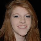 Young redheaded woman grinning