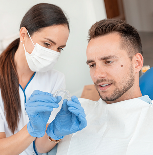 Dentist showing Invisalign to a patient