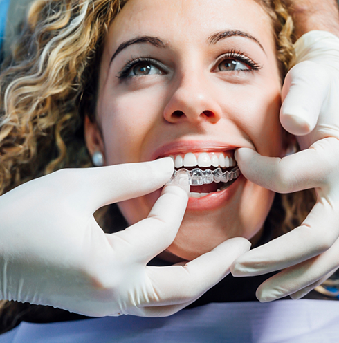 Dentist fitting a patient with Invisalign