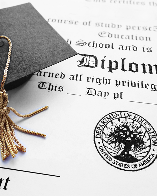 Graduation cap on top of a diploma