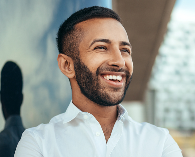 Man in white collared shirt smiling with minimal prep veneers in Virginia Beach