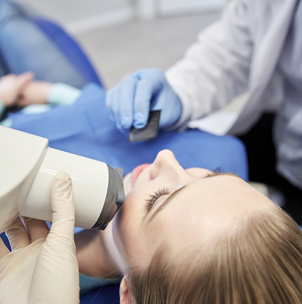 Dental patient having her teeth scanned