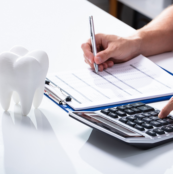 Person filling out a dental insurance form