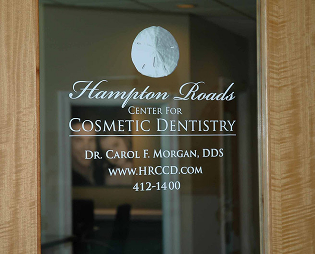 Front door of Virginia Beach dental office with sign reading Hampton Roads Center for Cosmetic Dentistry