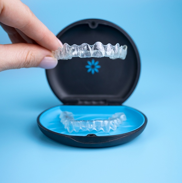 Invisalign aligner being placed into its storage case