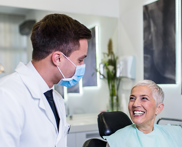 Senior woman smiling at her dentist during a preventive dentistry checkup