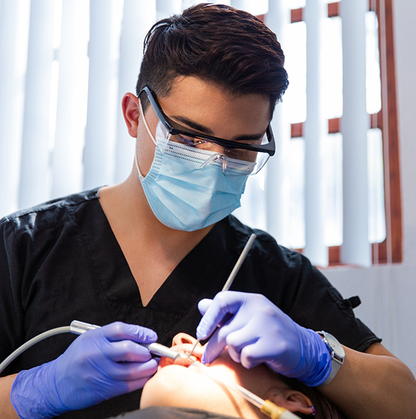 Dentist examining a patients mouth