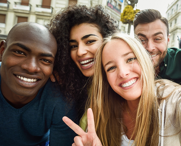 Selfie of four adults grinning after smile makeovers in Virginia Beach